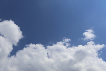 White clouds drifting across a vibrant blue sky