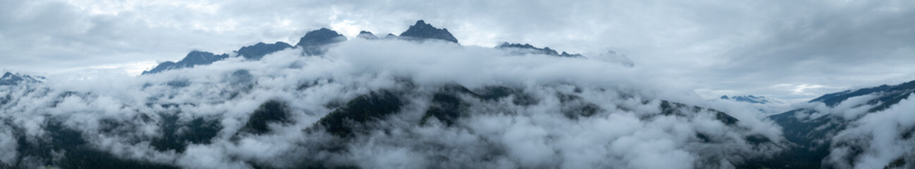 Aerial view of beautiful foggy forest and rocky  mountains landscape