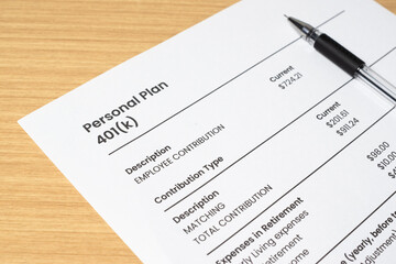 Obraz premium Retirement banking plan 401k and white pen on a white background. Close-up