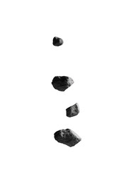 Naklejka premium Several gray stones falling vertically against a black backdrop