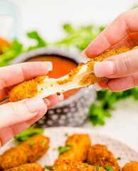 Crispy, Cheesy Mozzarella Sticks Pulled Apart Showing Melty Cheese