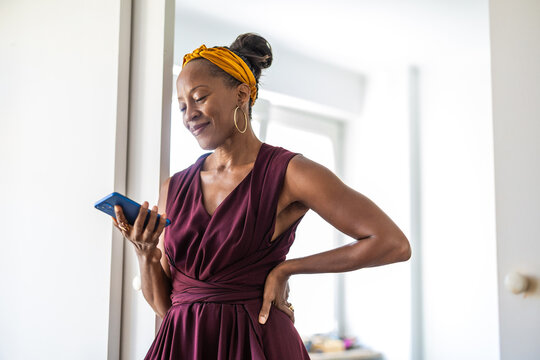 Portrait of smiling businesswoman using mobile phone in office