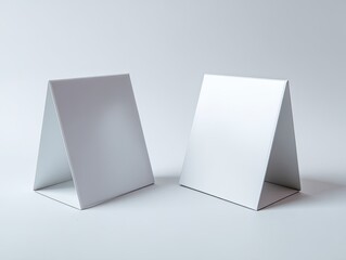 Naklejka premium Two blank white triangular table tents stand apart