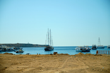 View from the shore to the sea with yachts that set sail