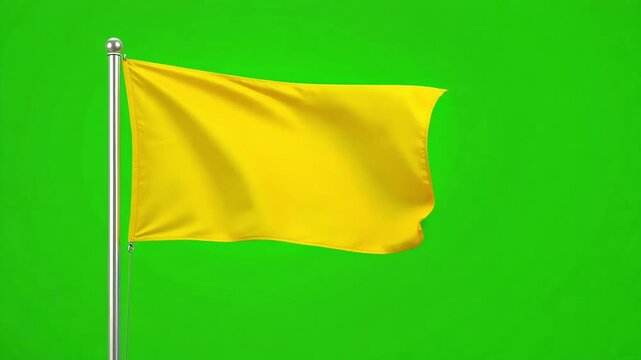 Bright yellow flag waves gently against a vibrant green background, symbolizing caution or a warning.