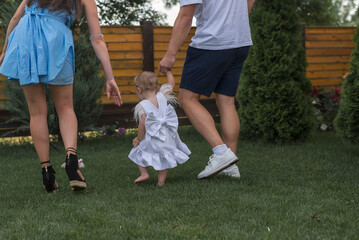 Happy family walk in nature. Dad, mom and little daughter, free and active people in nature
