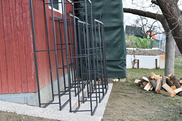 Red wooden house with choped wood for heating in the winter