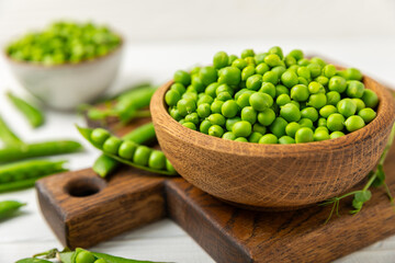 Fresh green pea pods with green peas on a wooden background. Sweet green peas. Green pea beans vegetables. Vegan. healthy vegetable. Copy space