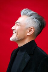 Red solid background. Trendy men's layered cut haircut - midlife southeast asian man with middle hair. An expressive midlife man with a fashionable style. Visual layout of style for aging men.
