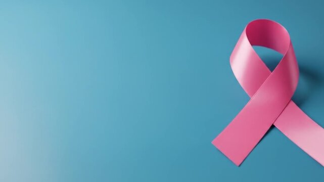 Pink ribbon on blue background symbolizing awareness and hope for healthcare campaigns and charitable support
