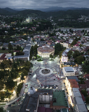 Aerial view of the vibrant city square, where the Tsereteli Statue stands in stark contrast to the backdrop of the distant mountains, Kutaisi, Imereti, Georgia.
