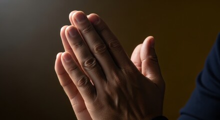 Closeup of hands clasped together in prayer, symbolizing faith and hope