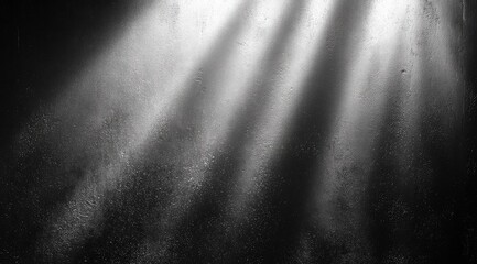 Abstract grayscale image.  Light beams cast dramatic shadows on a textured surface