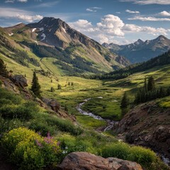 Naklejka premium Lush green valley with a winding stream, majestic mountains, and vibrant wildflowers