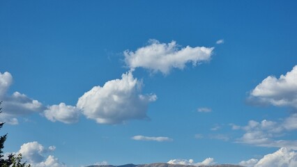 clouds traveling in blue autumn sky