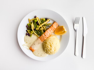 Plate with salmon, mashed potatoes and vegetables. Healthy eating, balanced nutrition and traditional lunch option.