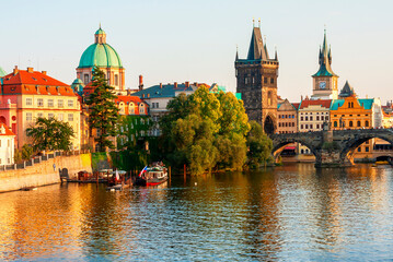 Charles Bridge over Vltava river and architecture of the Old Town in Prague, Czech republic. Pleasure ship on the Vltava river in Prague. Charles Bridge the main attraction of Prague in Czech republic