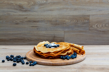Sweet morning delight: thin crepes with blueberries and sugar powder