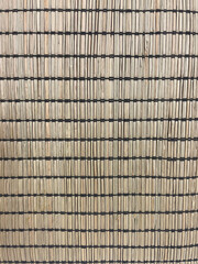 Close-up of a natural bamboo mat texture with horizontal black thread weaving. Eco-friendly organic background, perfect for interior design, decoration, Asian style, or eco product presentation.