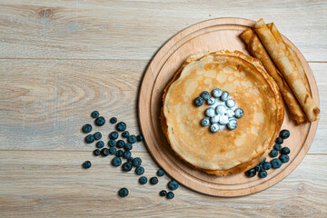 Sweet morning delight: thin crepes with blueberries and sugar powder