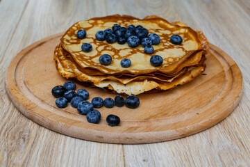 Sweet morning delight: thin crepes with blueberries and sugar powder