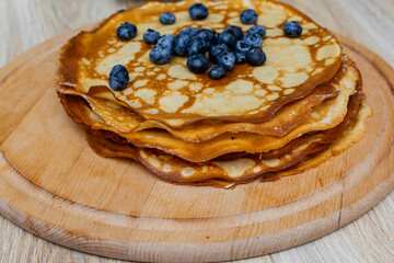 Sweet morning delight: thin crepes with blueberries and sugar powder