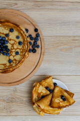 Sweet morning delight: thin crepes with blueberries and sugar powder