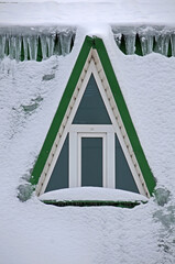 Snowy attic window in winter