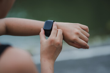 Woman using smartwatch during outdoor workout