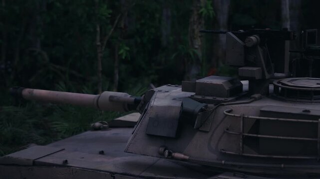 An armored tank is stationed within a lush jungle environment at twilight. The tank shows signs of wear while its turret faces forward, ready for potential action amidst the natural surroundings.