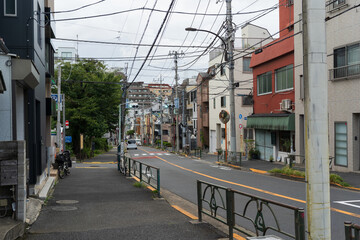 Curved Street with Houses and Walls in Tokyo Neighborhood