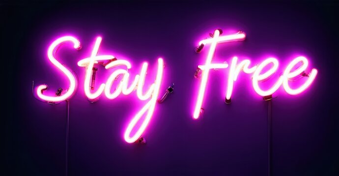 Bright pink neon sign displays Stay Free against dark purple wall. Simple script font creates vibrant, modern aesthetic.