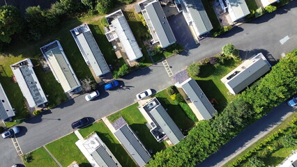 Elevated aerial shot of caravan park with coastline backdrop – versatile stock for travel,...