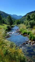 Fototapeta premium Scenic river flowing through a verdant valley under a clear blue sky