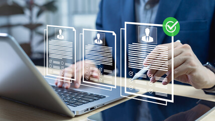 HR managers reviewing applicant resumes with ranking systems and recruiting checklists. Evaluating...