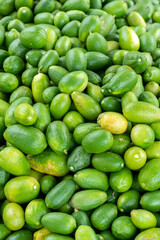 Pile of Fresh Green Limes A Vibrant Citrus Bounty. Fresh green limes are small, sour citrus fruits, bright green and firm with smooth skin, that are rich in vitamin C and antioxidants.