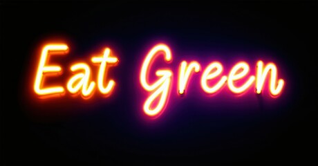 Bright neon sign displays text Eat Green. Vivid orange, pink glow against dark background. Simple message, inviting viewers.