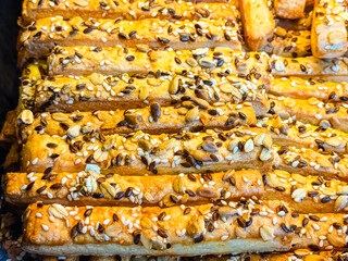 Crunchy breadsticks topped with mixed seeds. Healthy snacking, nutrition and bakery lifestyle with...