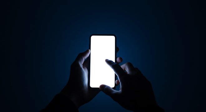 A person's hands holding and interacting with a glowing smartphone screen against a dark background.