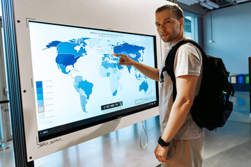 Man Interacting with Digital World Map on CO2 Emissions