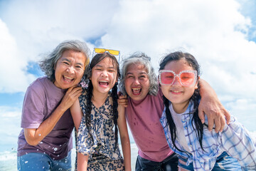 Group of Happy Asian multi-generation women family travel nature ocean on summer beach holiday...