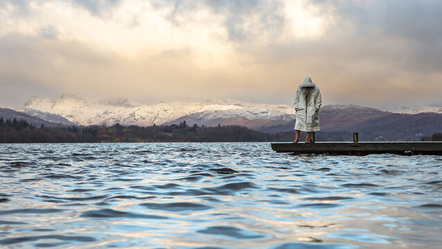 Man with beard in a white swim robe in the Lake District - Powered by Adobe
