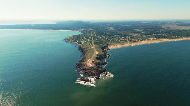 Aerial view of Punta Ballena peninsula stretching into the Atlantic with scenic beaches