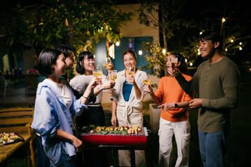 Friends toasting drinks at barbecue backyard party