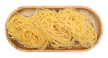 Uncooked italian taglierini ruvidi pasta in wooden bowl isolated on white, top view