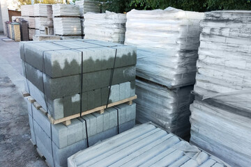 Concrete building materials on wooden pallets outdoors during daytime.