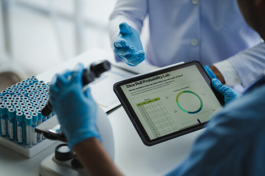 Scientists analyzing data and statistics on digital tablet in laboratory