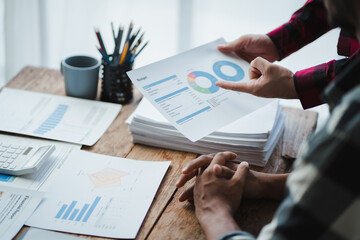 Business people analyzing financial charts and explaining budget at meeting