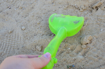 children’s sandbox colorful wooden outdoor playground sand small green toy shovel inside...