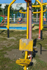 outdoor gym equipment with seats and metal handles installed on public sports ground, fitness machine for street workout and physical activity